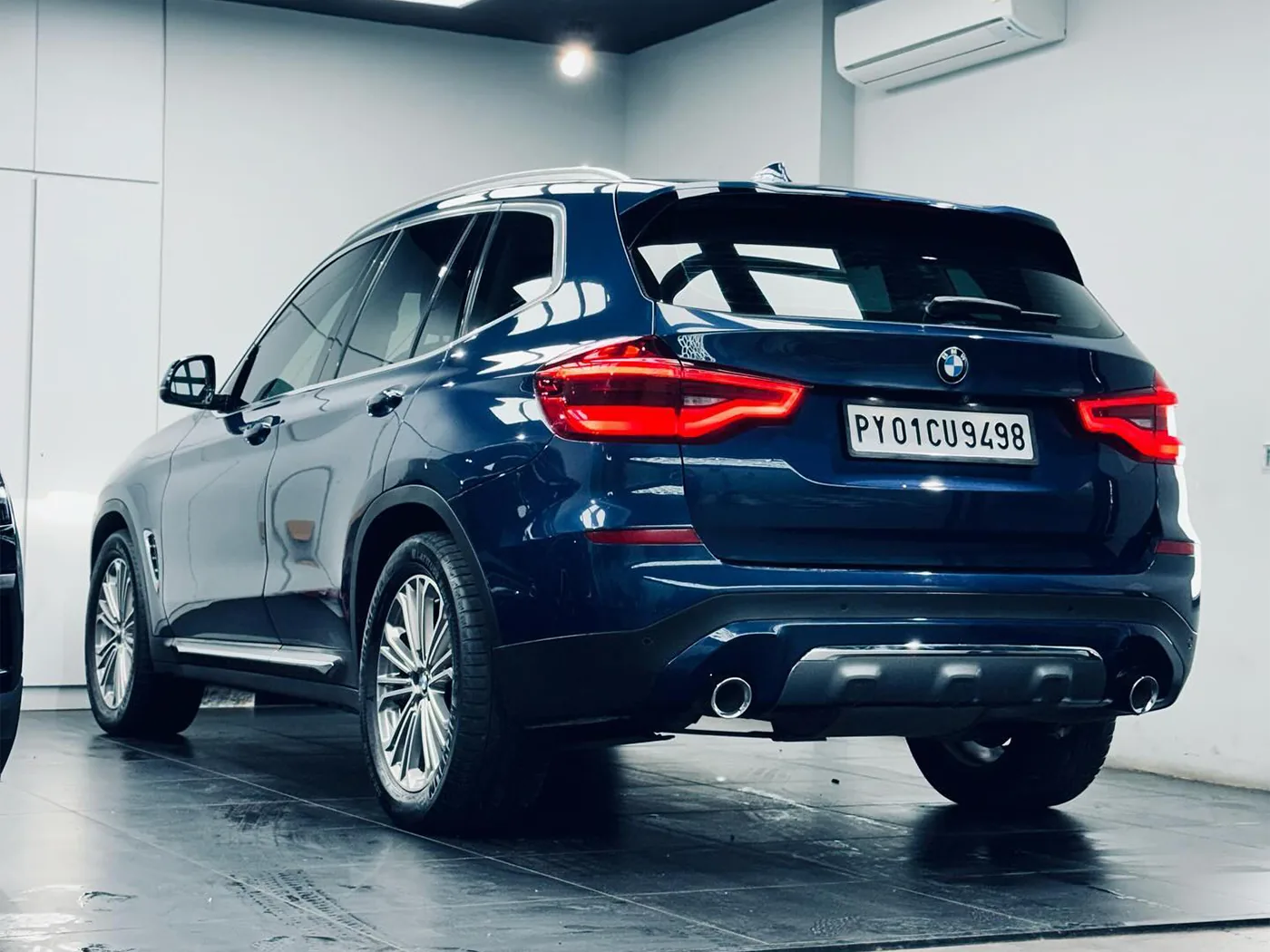 A navy blue BMW X3, washed and dried, at The Detailing Mafia ECR studio